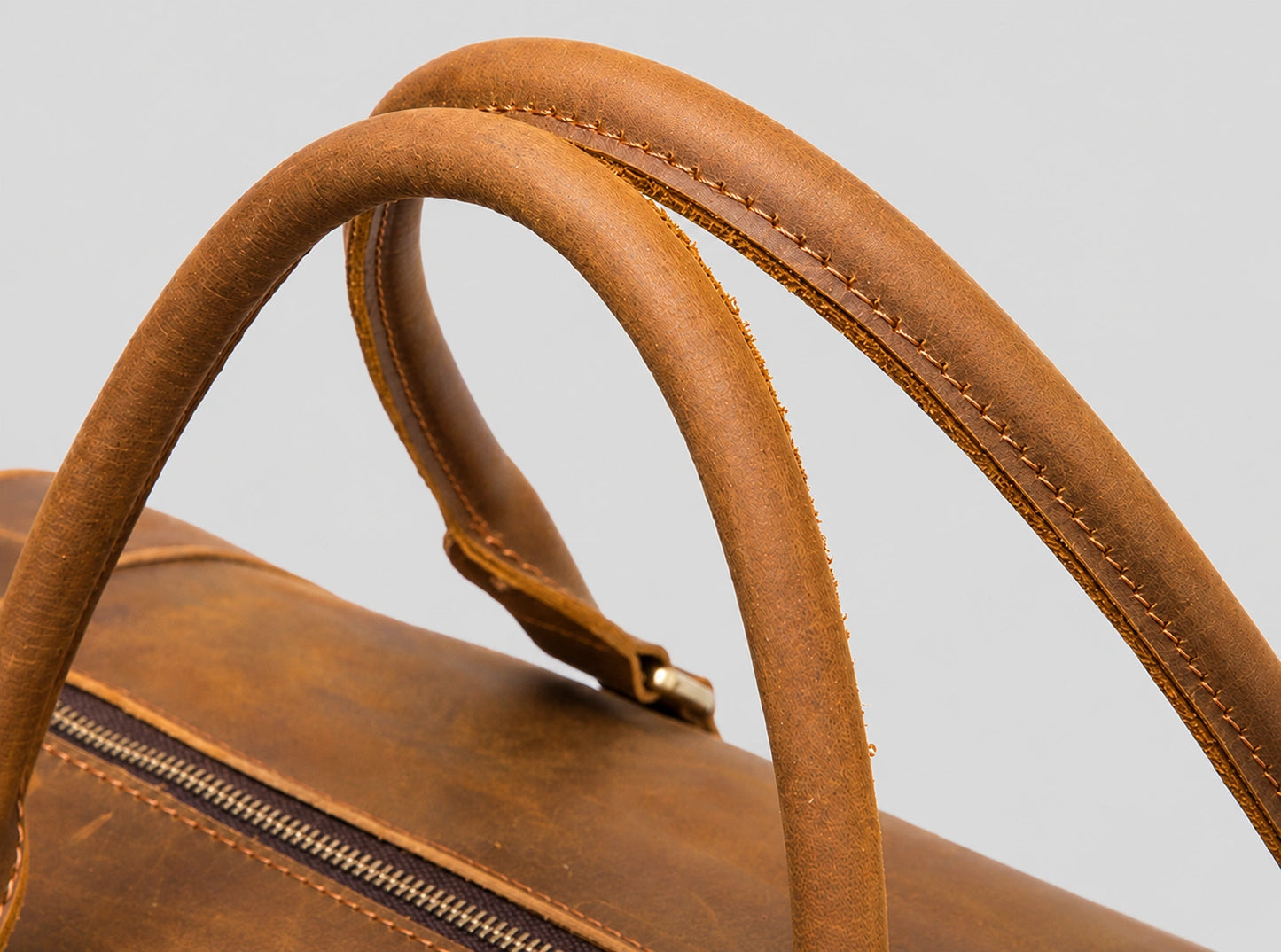 Premium leather carry handle detail on vintage duffel bag