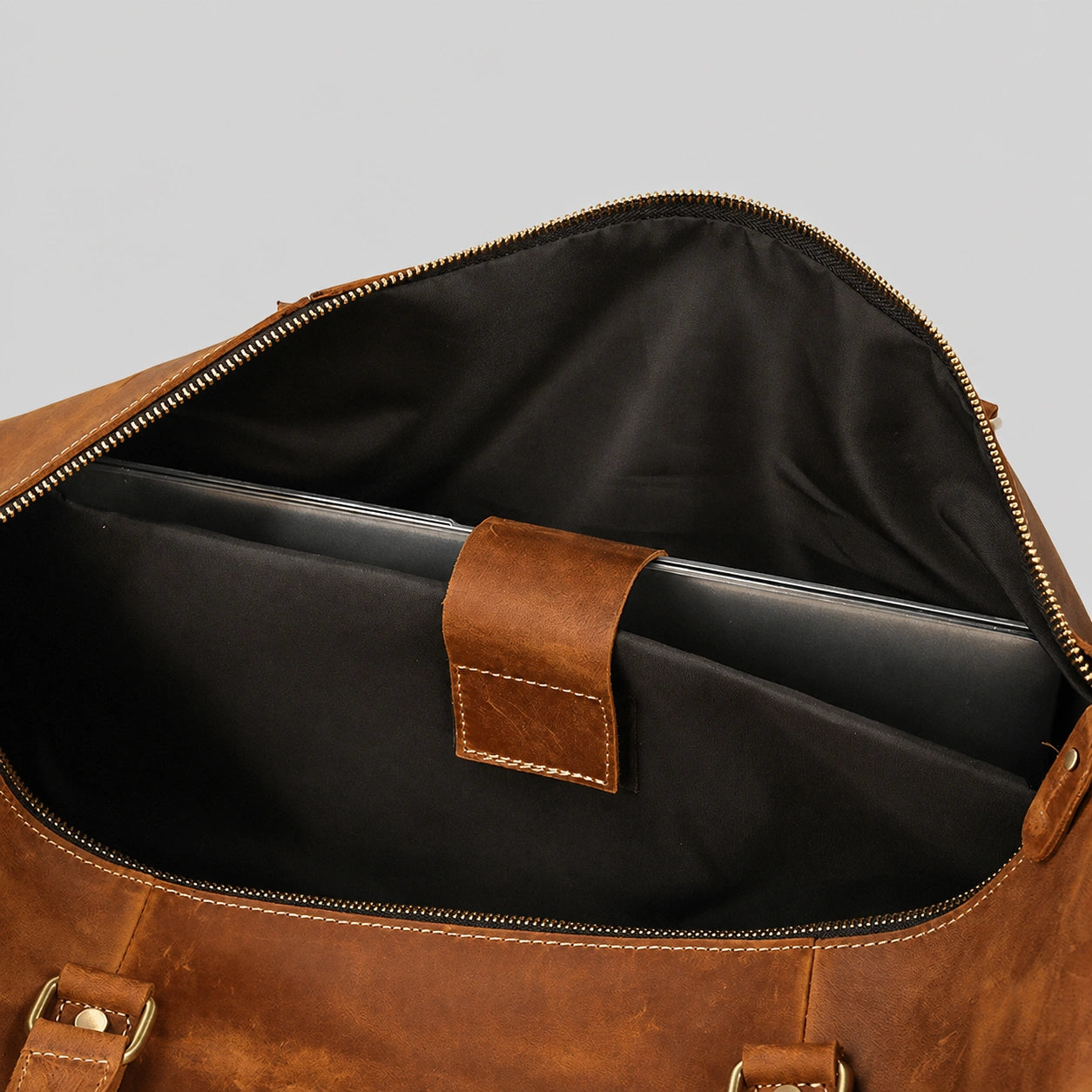Spacious interior compartment of leather weekender bag