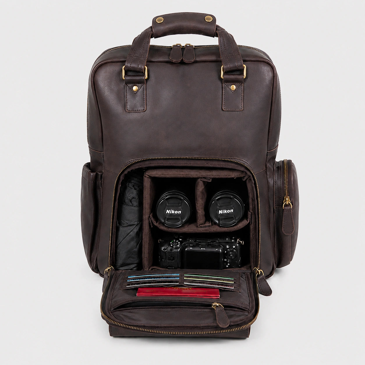 Vintage Crazy Horse leather camera backpack in dark brown, open front compartment showing Nikon DSLR camera, two lenses, and organized accessories, premium handcrafted leather with adjustable shoulder straps, ideal for travel and photography