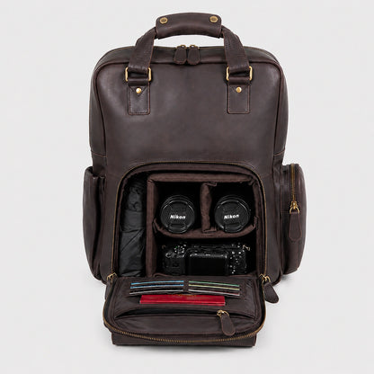 Vintage Crazy Horse leather camera backpack in dark brown, open front compartment showing Nikon DSLR camera, two lenses, and organized accessories, premium handcrafted leather with adjustable shoulder straps, ideal for travel and photography