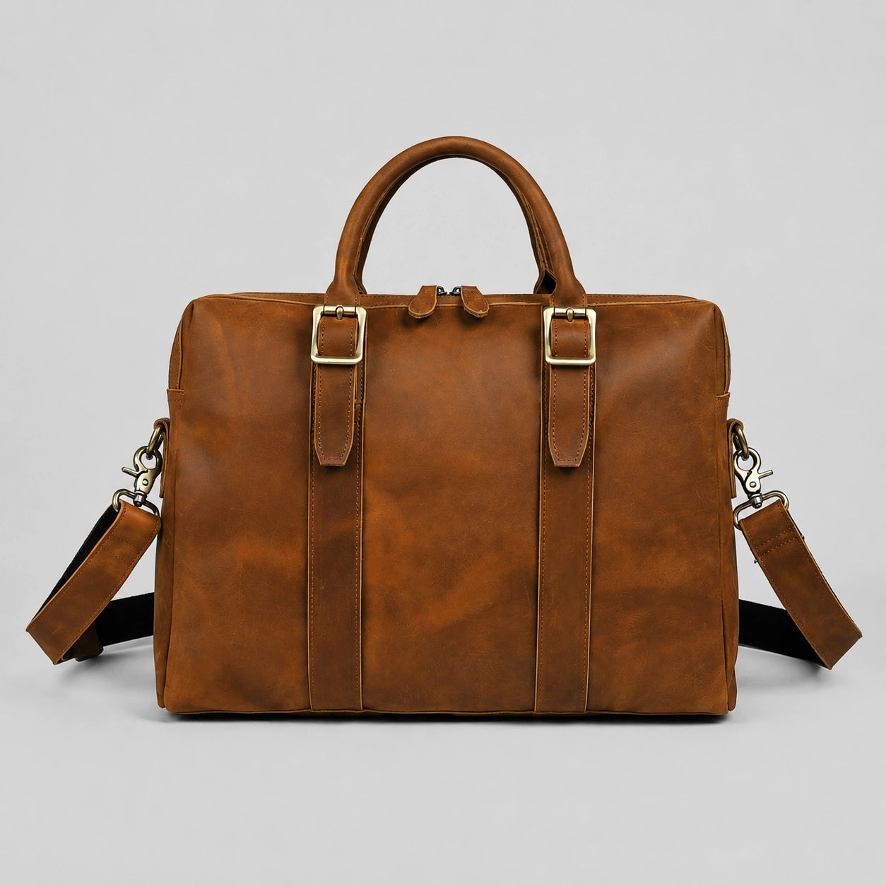 Vintage brown crazy horse leather briefcase front view with handles and adjustable strap