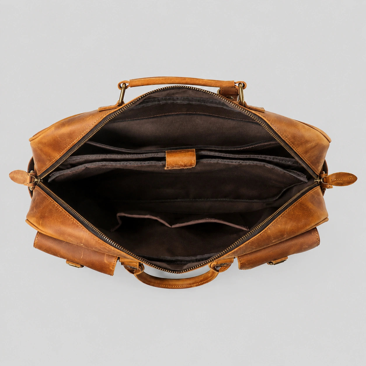 Interior view of leather briefcase showing spacious laptop compartment and organizational pockets